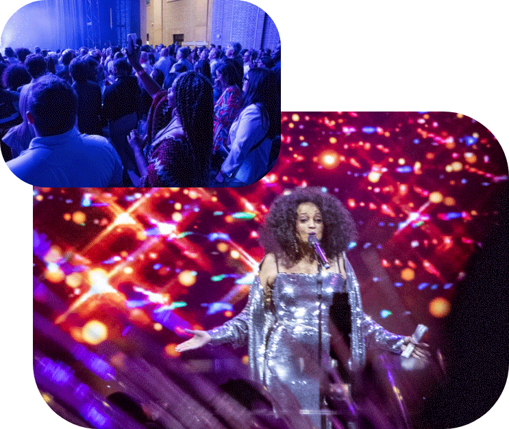 A crowd watches a performer on stage. In front, a woman in a sparkling silver dress sings into a microphone against a vibrant, colorful light display.