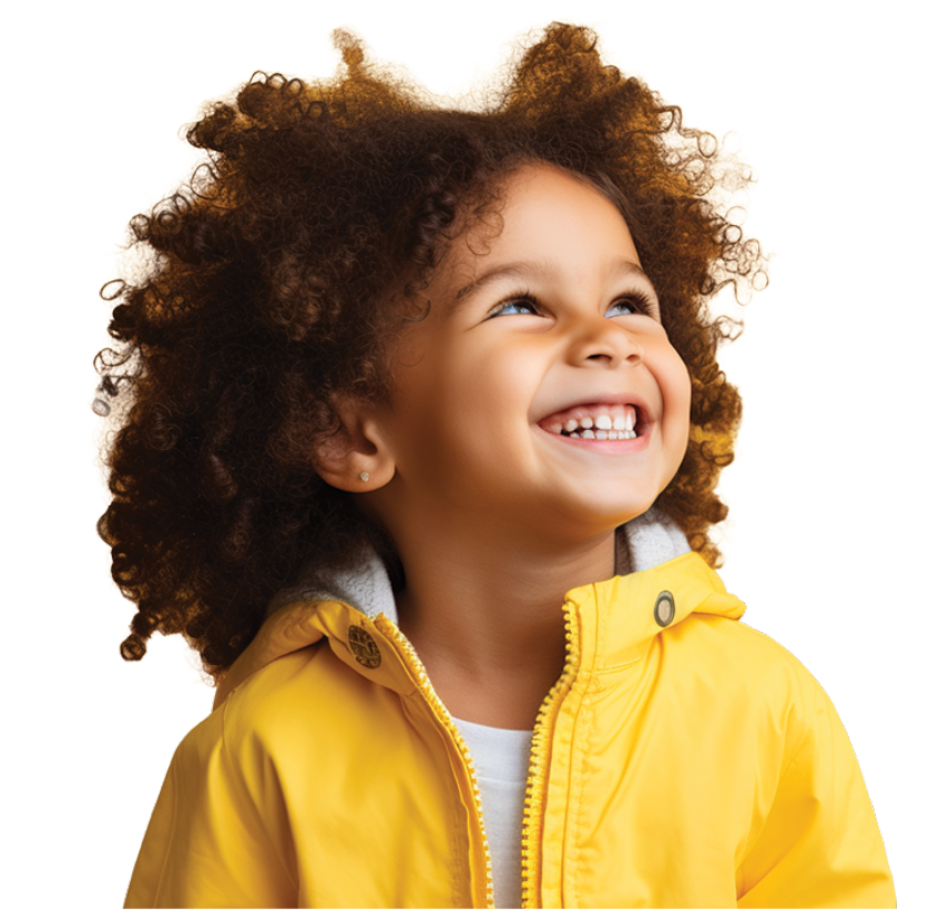 Smiling young child with curly hair wears a yellow jacket, looking up with joy against a plain, light background.