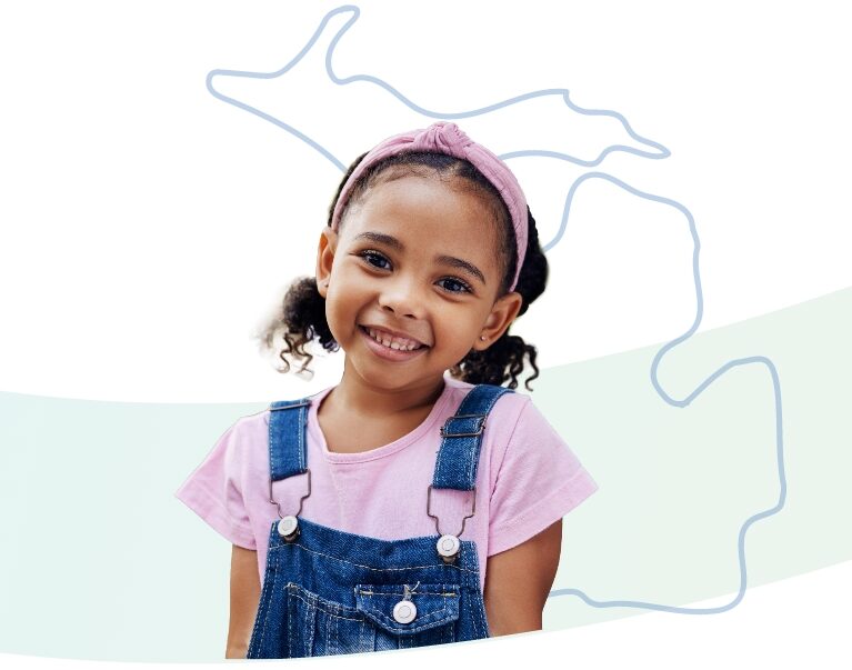 A young girl with curly hair in pigtails, wearing a pink headband, pink shirt, and denim overalls, smiles at the camera. The outline of the state of Michigan is drawn in the background.